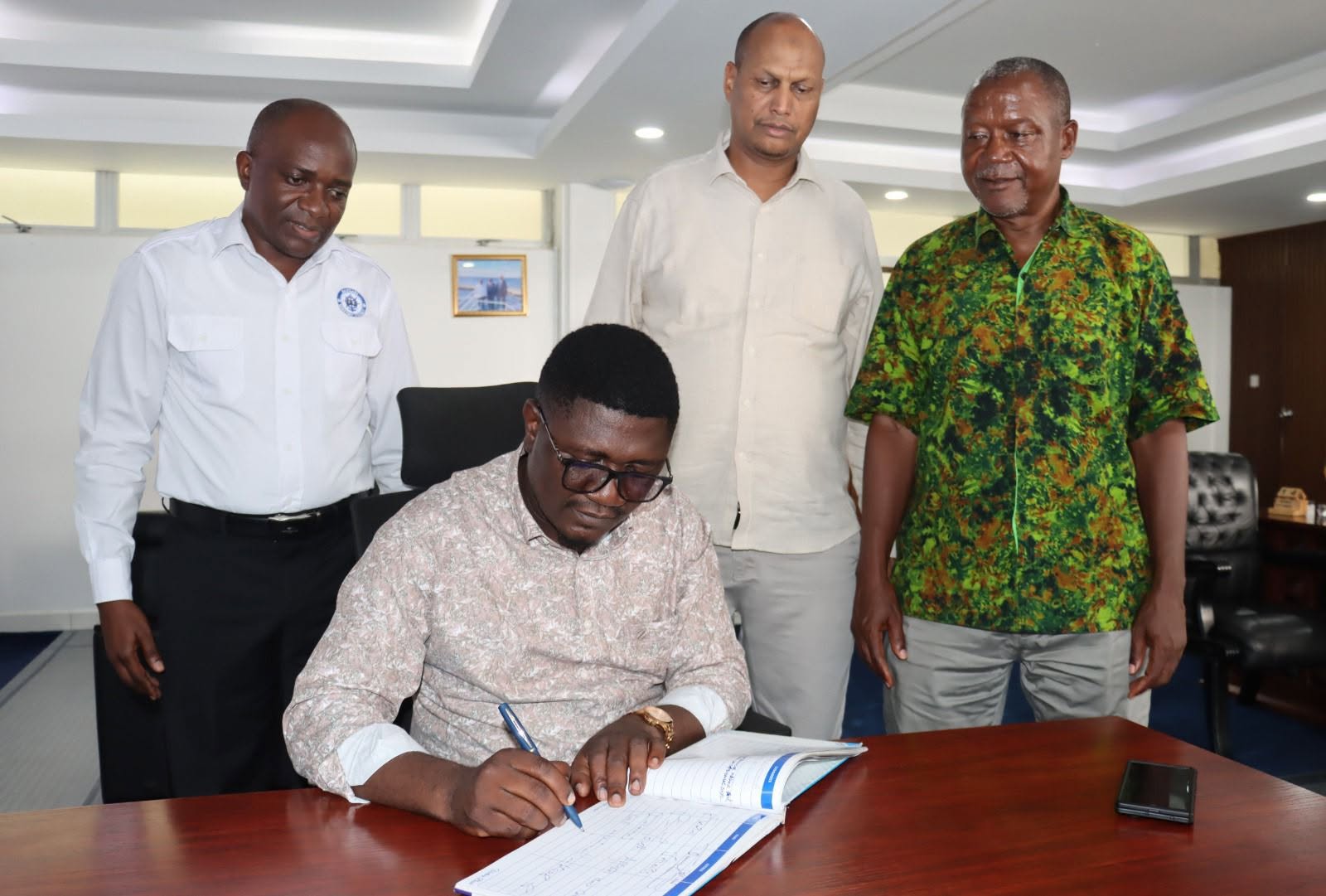 State Department for Shipping and Maritime Affairs, Mr. Aden A. Millah joins his counterpart Principal Secretary, State Department for Youth Affairs and Creative Economy, Mr. Fikirini Jacobs at Bandari Maritime Academy (BMA) while a visitor's book