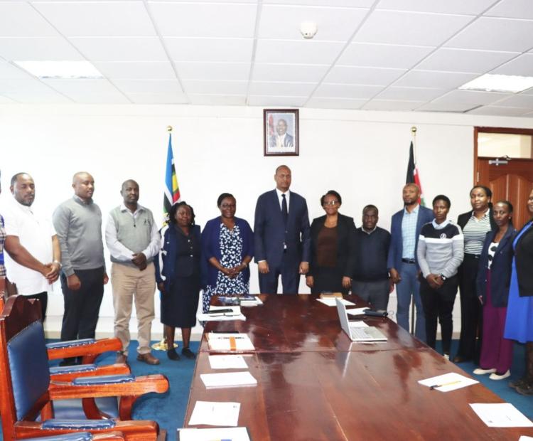 The Principal Secretary for the State Department for Shipping and Maritime Affairs, Mr. Aden Millah, poses for a group photo with staff from the Procurement Department.