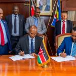 On the right, CS Ali Hassan Joho and on the left, PS Aden Millah during PC Signing.