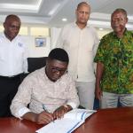 State Department for Shipping and Maritime Affairs, Mr. Aden A. Millah joins his counterpart Principal Secretary, State Department for Youth Affairs and Creative Economy, Mr. Fikirini Jacobs at Bandari Maritime Academy (BMA) while a visitor's book